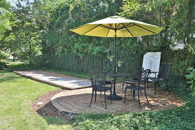 view of patio / terrace with a forest view and outdoor dining area