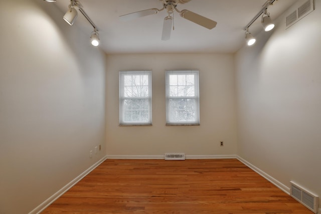 spare room featuring light wood-style flooring and visible vents