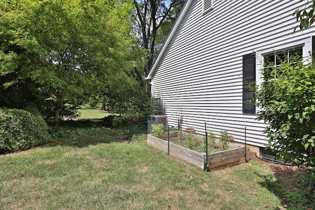 view of yard with central AC and a vegetable garden