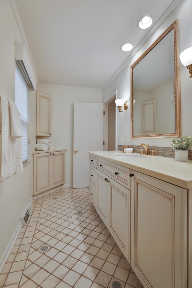 bathroom featuring ornamental molding, recessed lighting, vanity, and baseboards