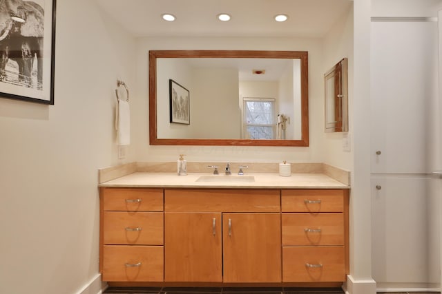 bathroom featuring recessed lighting and vanity