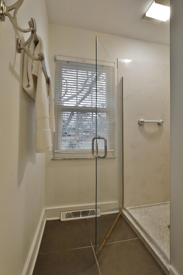 full bath with tile patterned flooring, a shower stall, visible vents, and baseboards