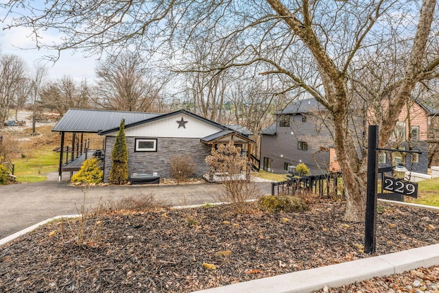 view of property exterior with stone siding and metal roof