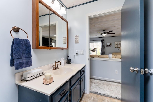 bathroom featuring baseboards, a ceiling fan, and vanity