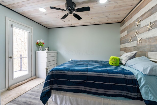 bedroom featuring wood walls, wood ceiling, access to outside, and wood finished floors