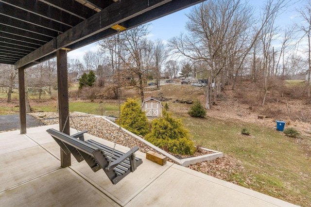 view of patio featuring an outdoor structure and a shed