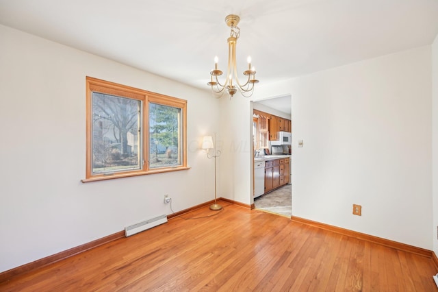 unfurnished room featuring a notable chandelier, light wood-type flooring, baseboards, and a baseboard radiator