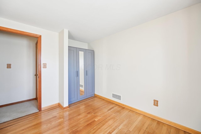 spare room with visible vents, baseboards, and light wood-style floors