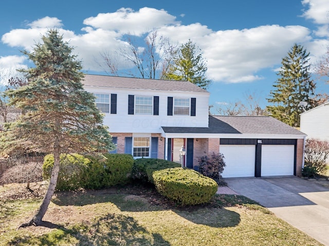 view of front of house featuring a garage, a front yard, brick siding, and driveway