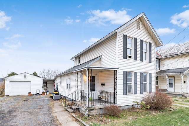 view of front of property with a garage, an outdoor structure, and covered porch