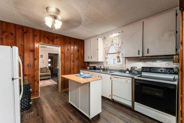 kitchen with sink, white appliances, dark wood-type flooring, and white cabinets