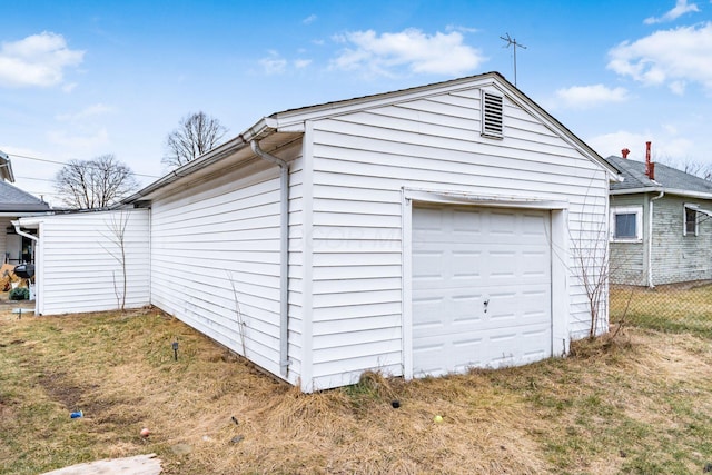 garage featuring a lawn