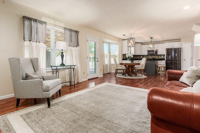 living room with dark wood finished floors and baseboards