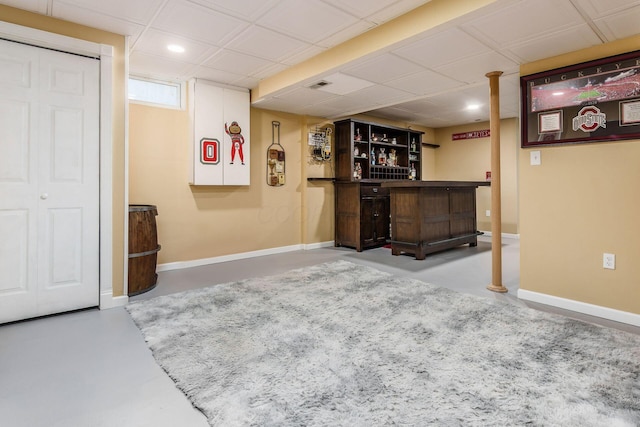 interior space with concrete flooring, a dry bar, recessed lighting, and baseboards