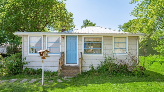 109 Beacon Light Ln, Buckeye Lake, OH 43008 - bungalow with a front lawn, metal roof, and a chimney