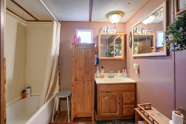 bathroom with shower / bath combination with curtain, vanity, and a textured ceiling