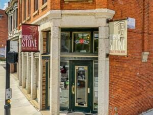 doorway to property featuring brick siding