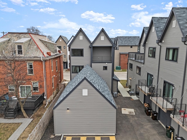 rear view of house featuring fence