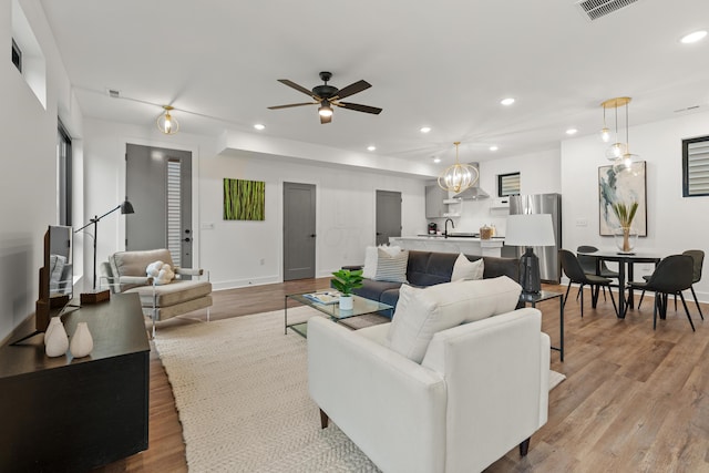 living area with recessed lighting and wood finished floors