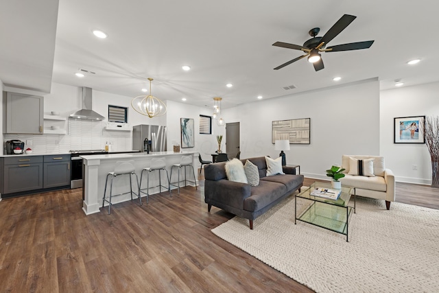 living room featuring baseboards, ceiling fan with notable chandelier, dark wood finished floors, and recessed lighting