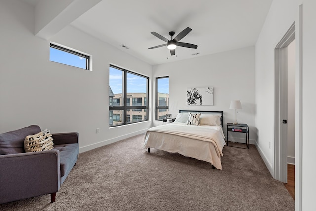 bedroom with carpet, visible vents, ceiling fan, and baseboards