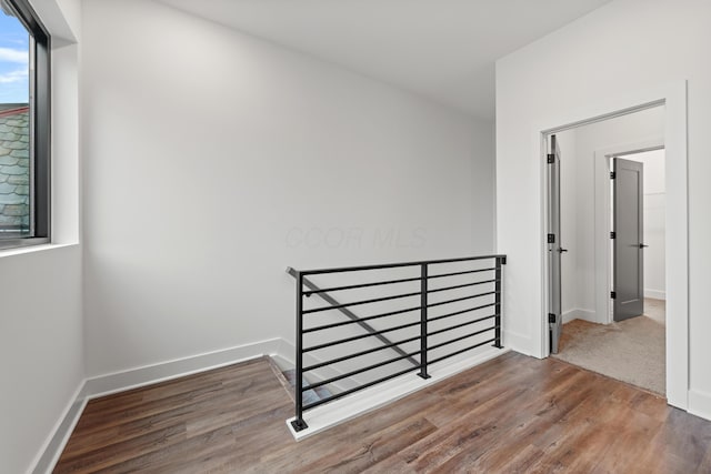 interior space featuring baseboards and wood finished floors