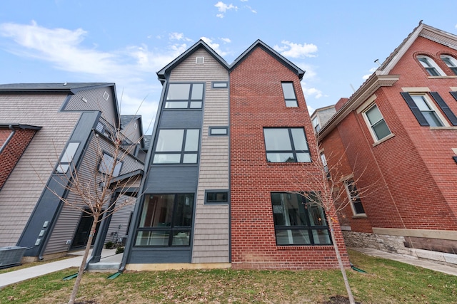 view of building exterior with central AC unit