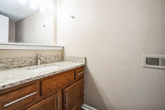 bathroom featuring vanity and a textured ceiling