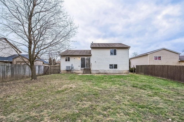 rear view of property featuring a lawn