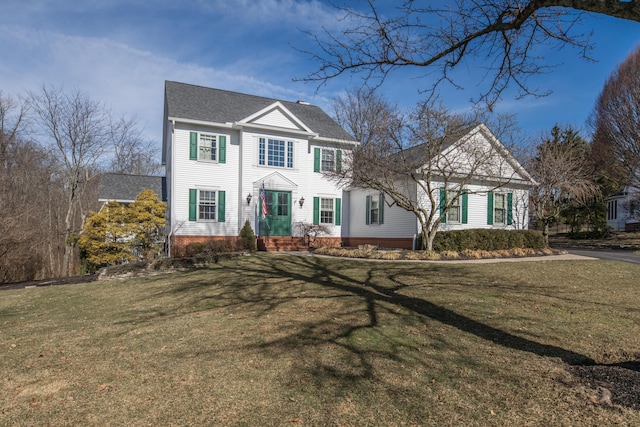 colonial-style house with a front yard