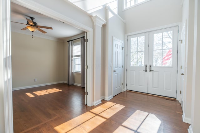 entryway with french doors, crown molding, and dark hardwood / wood-style floors