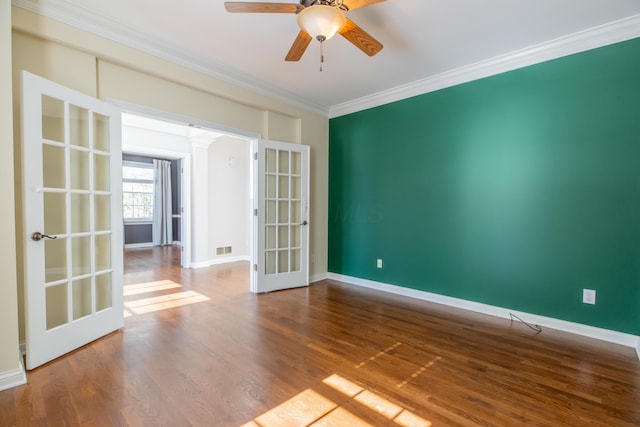 empty room with ceiling fan, ornamental molding, french doors, and hardwood / wood-style floors