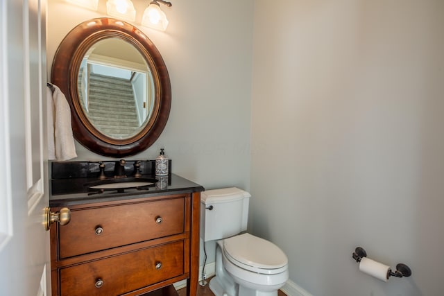 bathroom featuring toilet and vanity