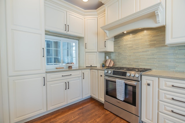 kitchen with white cabinets, gas stove, custom exhaust hood, and light stone counters