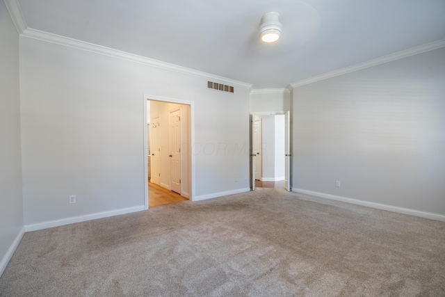 unfurnished bedroom featuring light carpet and crown molding