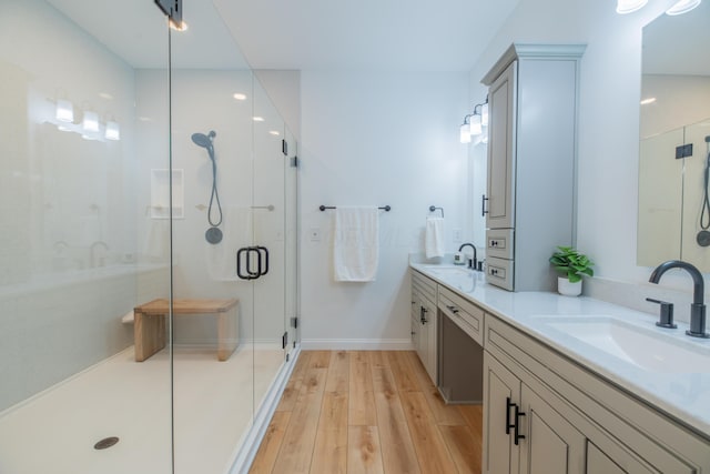 bathroom featuring hardwood / wood-style floors, vanity, and walk in shower