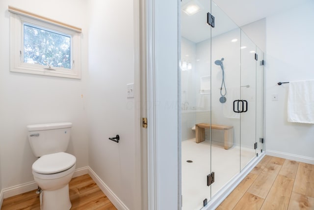 bathroom featuring toilet, walk in shower, and hardwood / wood-style floors