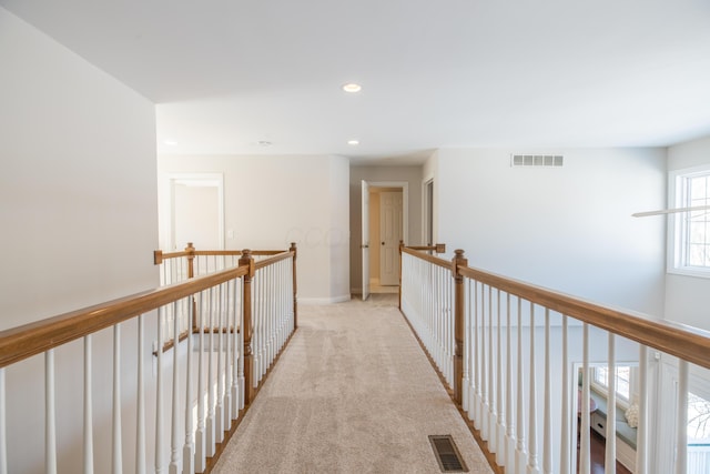 corridor featuring light colored carpet