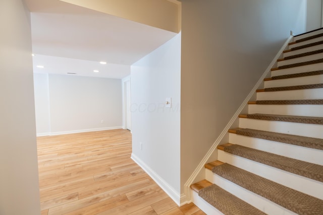 stairway featuring hardwood / wood-style flooring