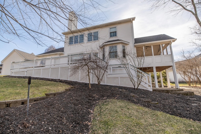 view of front of property featuring a sunroom and a front lawn