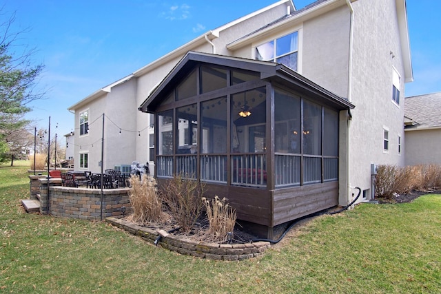 6268 Bellow Valley Dr, Dublin, OH 43016 - back of house featuring a patio, a lawn, a sunroom, and stucco siding