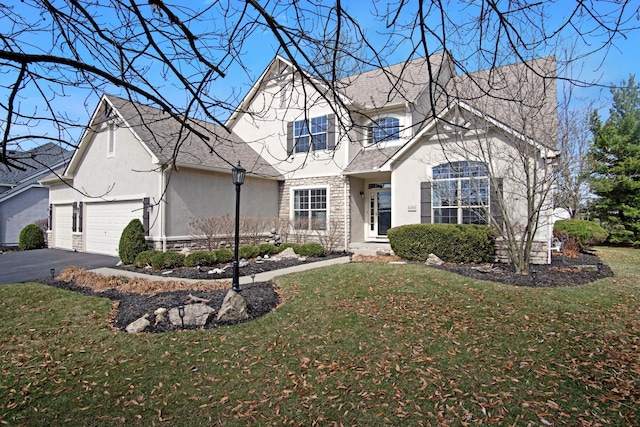 6268 Bellow Valley Dr, Dublin, OH 43016 - view of front of home with stucco siding, a front yard, a garage, and driveway