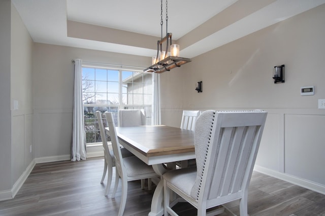 6268 Bellow Valley Dr, Dublin, OH 43016 - dining space with a decorative wall, a notable chandelier, wood finished floors, and a wainscoted wall