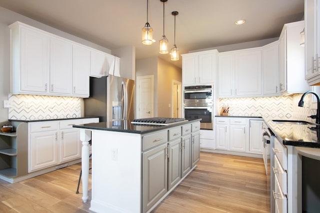 6268 Bellow Valley Dr, Dublin, OH 43016 - kitchen featuring a sink, dark countertops, appliances with stainless steel finishes, and a center island