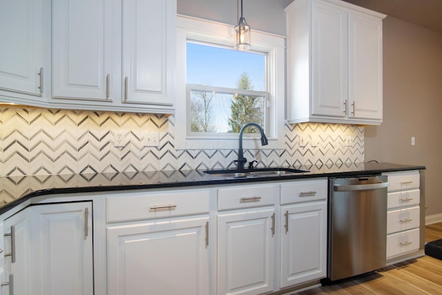 6268 Bellow Valley Dr, Dublin, OH 43016 - kitchen with a sink, white cabinets, dishwasher, dark countertops, and decorative light fixtures