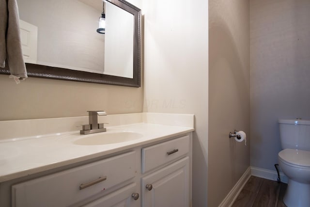 6268 Bellow Valley Dr, Dublin, OH 43016 - half bath featuring baseboards, toilet, wood finished floors, and vanity