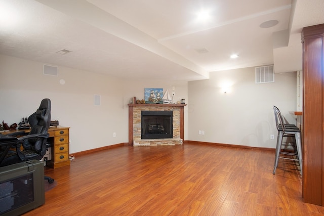 6268 Bellow Valley Dr, Dublin, OH 43016 - living room featuring visible vents, baseboards, wood finished floors, and a fireplace