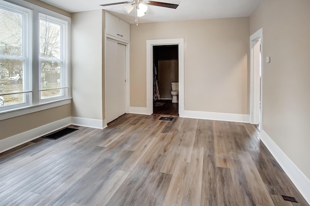 empty room featuring hardwood / wood-style floors and ceiling fan