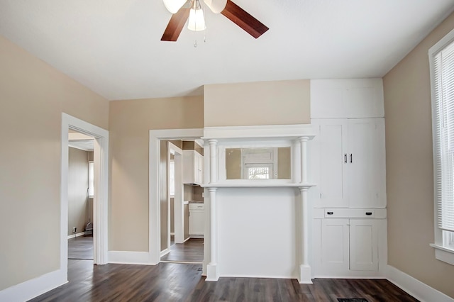 unfurnished living room with ceiling fan and dark hardwood / wood-style flooring