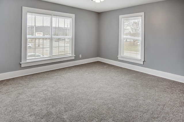 empty room featuring ceiling fan and carpet floors